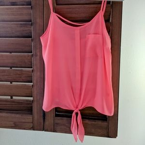 Candies sheer, loose fitting, bright pink tank top with a tie in the front.
